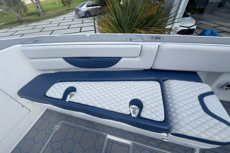 Slide: The Image of 2007 Intrepid 370 Center Console boat interior with blue and white cushioned seating. - 47