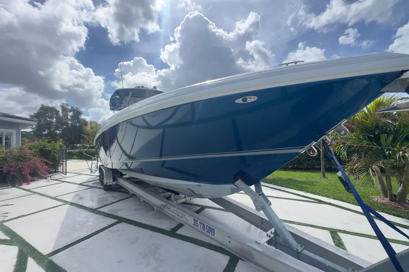 Slide: The Image of 2007 Intrepid 370 Center Console boat on trailer, under cloudy sky. - 5