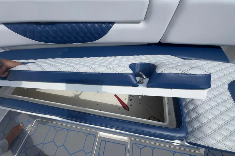 Slide: The Image of 2007 Intrepid 370 Center Console boat seat storage compartment with blue and white upholstery. - 55
