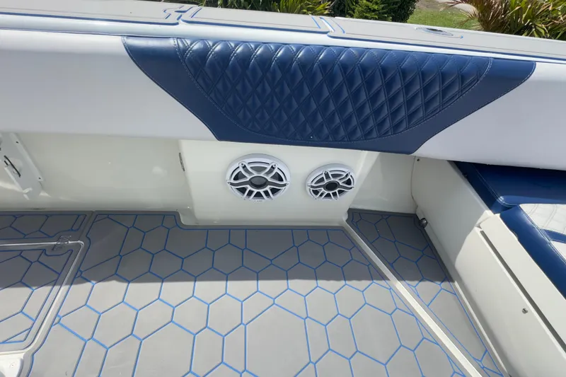 Slide: The Image of 2007 Intrepid 370 Center Console interior with blue diamond-pattern upholstery and dual speakers. - 59