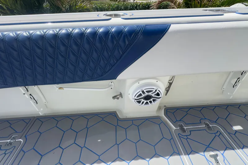 Slide: The Image of 2007 Intrepid 370 Center Console interior with blue quilted upholstery and speaker detail. - 65