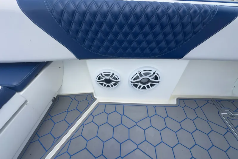 Slide: The Image of Blue and white interior of a 2007 Intrepid 370 Center Console boat with speakers. - 69