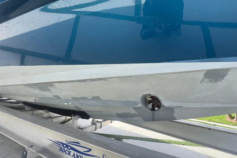 Slide: The Image of 2007 Intrepid 370 Center Console boat hull on trailer, showing maintenance work. - 7