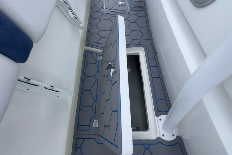 Slide: The Image of 2007 Intrepid 370 Center Console with open storage compartment and blue-accented flooring. - 71