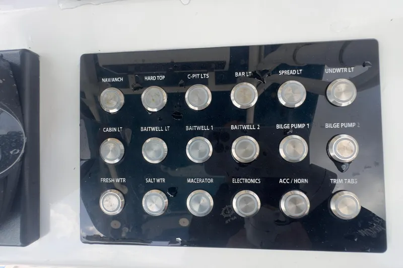 Slide: The Image of Control panel of a 2007 Intrepid 370 Center Console boat with labeled switches. - 79