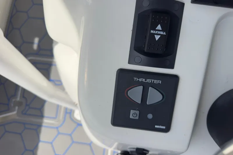 Slide: The Image of Control panel of a 2007 Intrepid 370 Center Console boat with thruster and Maxwell switch. - 85