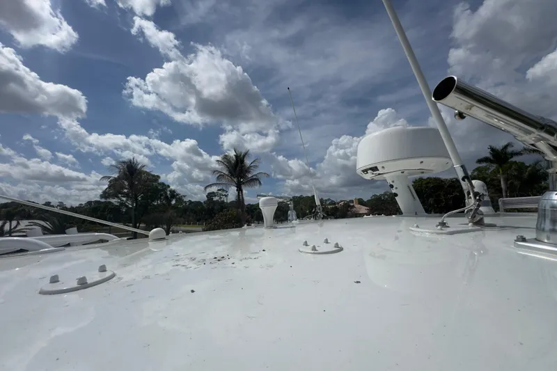 Slide: The Image of 2007 Intrepid 370 Center Console boat deck under a partly cloudy sky. - 90