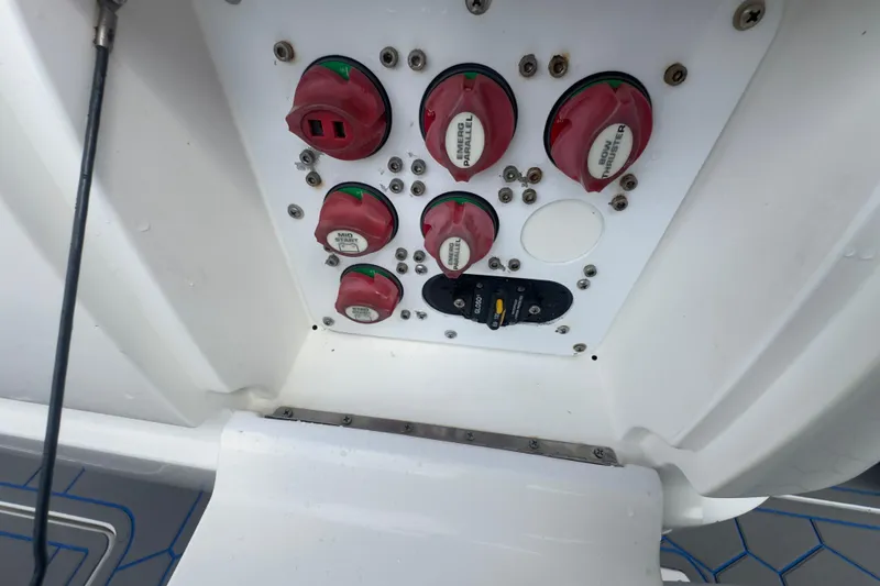 Slide: The Image of Control panel of a 2007 Intrepid 370 Center Console boat with red switches. - 96