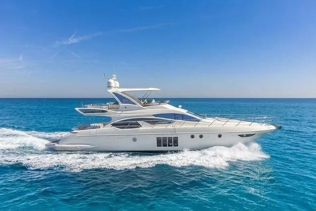 The Image of Luxury 2014 Azimut 64 yacht cruising on clear blue ocean waters. - 0