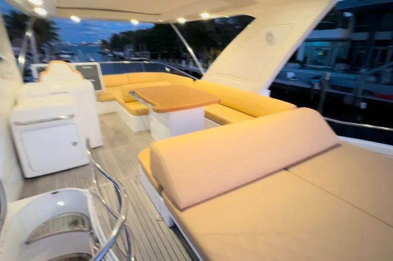 Slide: The Image of Luxurious seating area on a 2014 Azimut 64 yacht, docked at sunset. - 11