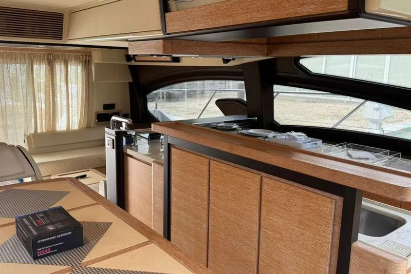 Slide: The Image of Control panel of a 2014 Azimut 64 yacht with steering wheel and Raymarine equipment. - 15