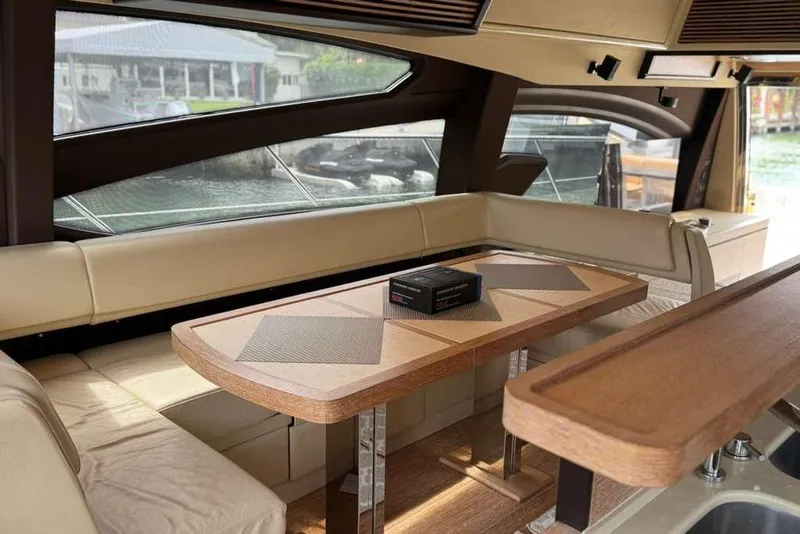 Slide: The Image of Luxurious interior of a 2014 Azimut 64 yacht with elegant seating and wooden table. - 18