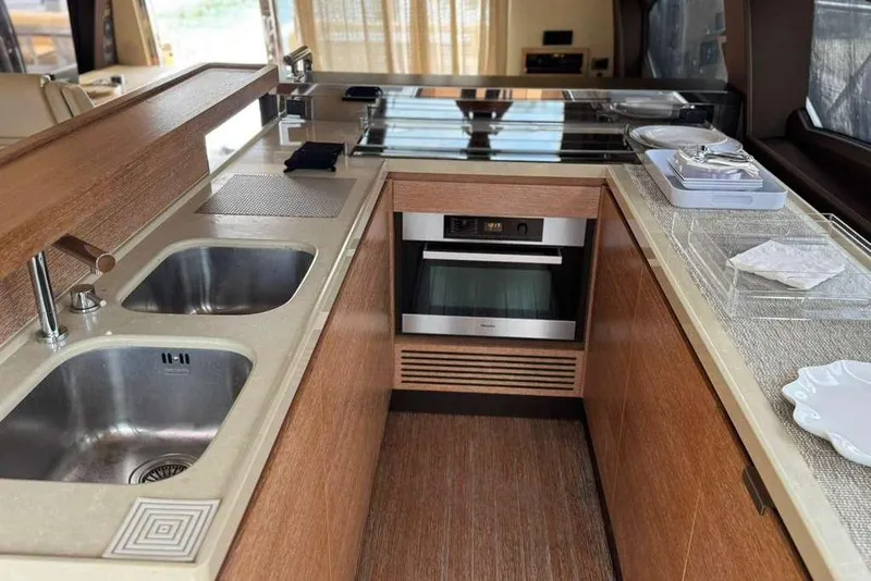 Slide: The Image of Luxurious interior of a 2014 Azimut 64 yacht with elegant seating and wooden table. - 19