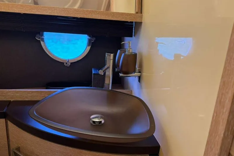 Slide: The Image of Luxurious bathroom in 2014 Azimut 64 yacht with modern fixtures and elegant design. - 22