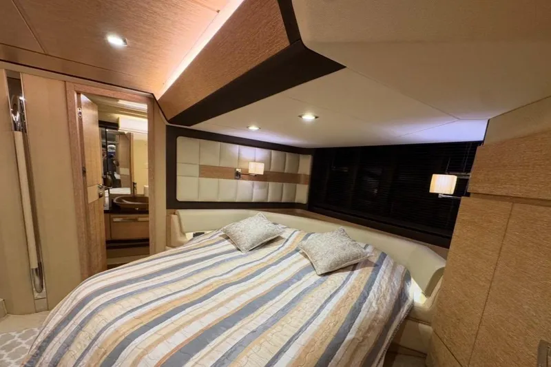 Slide: The Image of Luxurious bedroom interior of 2014 Azimut 64 yacht with striped bedding and modern decor. - 26