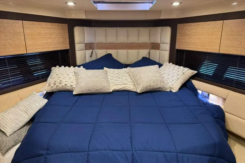 Slide: The Image of Luxurious bedroom interior of a 2014 Azimut 64 yacht, featuring elegant design and cozy lighting. - 27