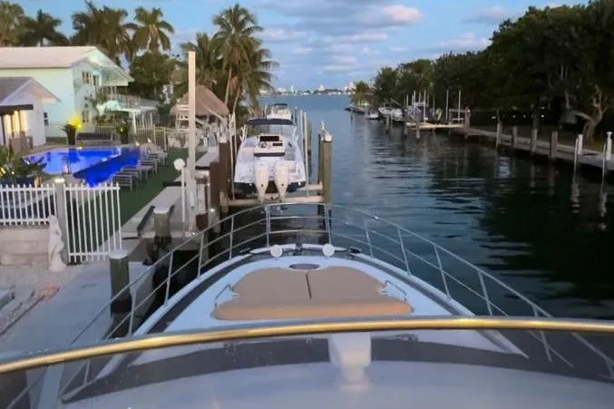 Slide: The Image of Luxurious 2014 Azimut 64 yacht docked at night with blue underwater lights. - 5
