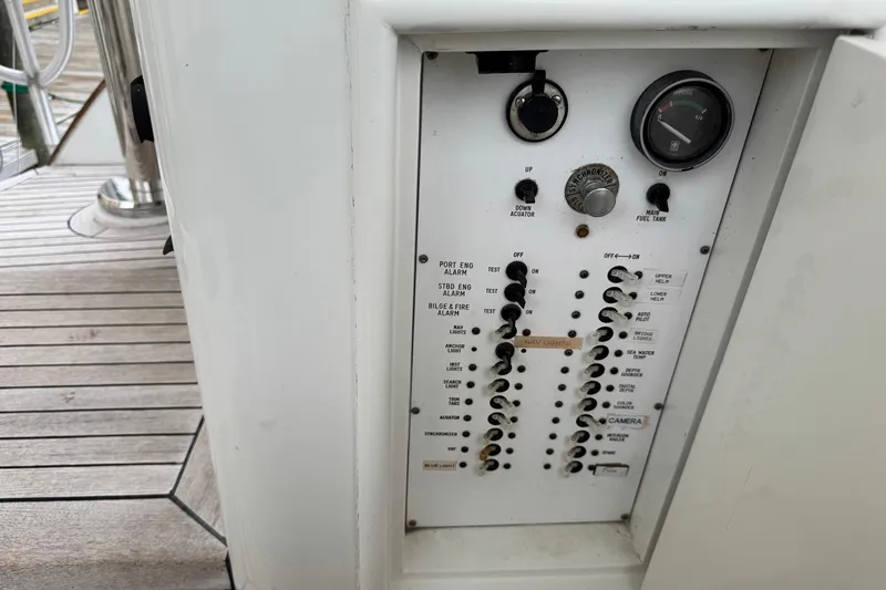 Slide: The Image of Control panel on a 1988 Buddy Davis 47 Convertible yacht, featuring switches and gauges. - 10