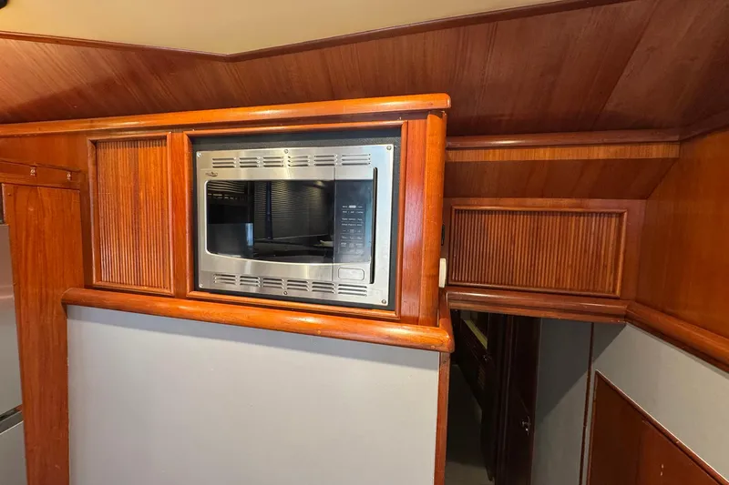 Slide: The Image of Wood-paneled interior of 1988 Buddy Davis 47 Convertible with built-in microwave. - 24