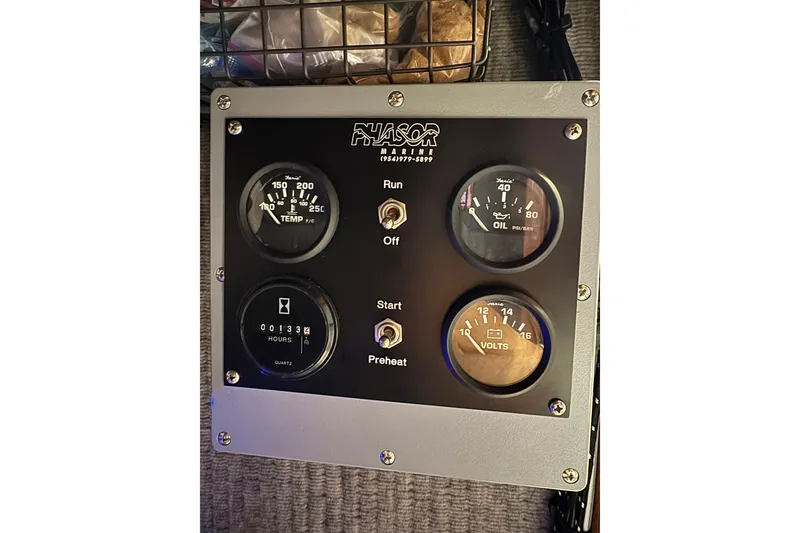 Slide: The Image of Phasor Marine control panel with gauges for temperature, oil, hours, and volts on a 1988 Buddy Davis 47 Convertible. - 30