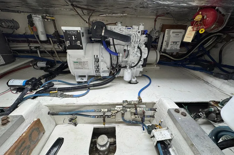 Slide: The Image of Engine room of a 1988 Buddy Davis 47 Convertible boat, showcasing mechanical components. - 37