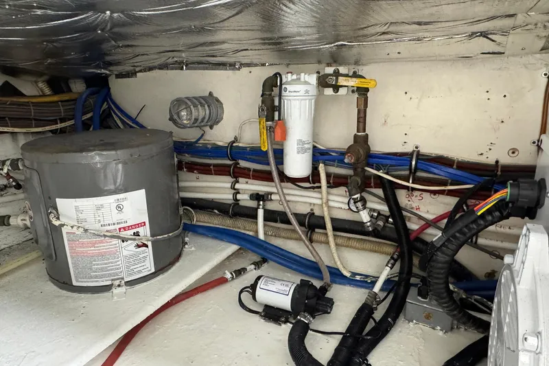 Slide: The Image of Engine room of a 1988 Buddy Davis 47 Convertible with wiring and plumbing components. - 39