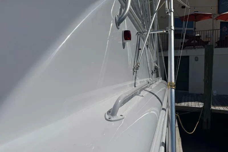 Slide: The Image of Side view of a 1988 Buddy Davis 47 Convertible yacht docked at a marina. - 5