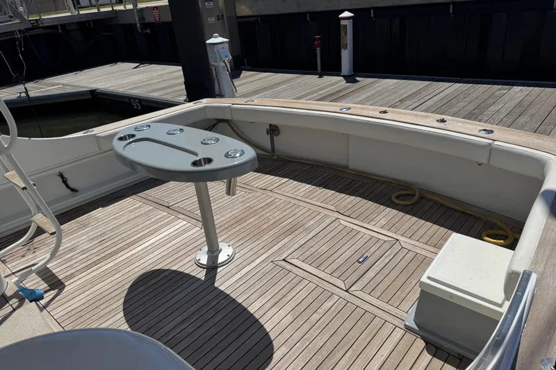 Slide: The Image of 1988 Buddy Davis 47 Convertible yacht deck with fishing rod holders and teak flooring. - 6