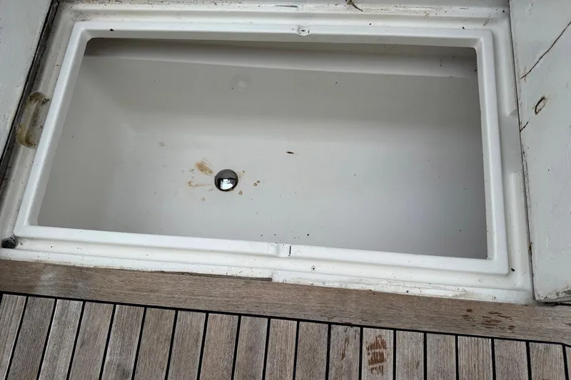 Slide: The Image of Empty storage compartment on 1988 Buddy Davis 47 Convertible boat deck. - 8