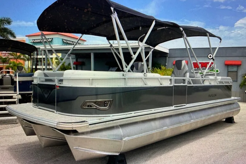 Slide: The Image of 2025 Avalon 2585 Venture High Performance Quad Lounge pontoon boat, parked outdoors. - 1