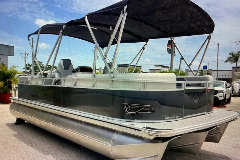 Slide: The Image of 2025 Avalon 2585 Venture High Performance Quad Lounge pontoon boat with canopy, parked outdoors. - 3
