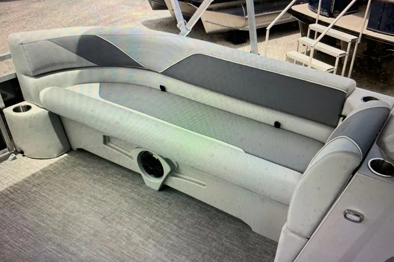 Slide: The Image of 2025 Avalon 2585 Venture Quad Lounge interior with gray seating and cup holders. - 5