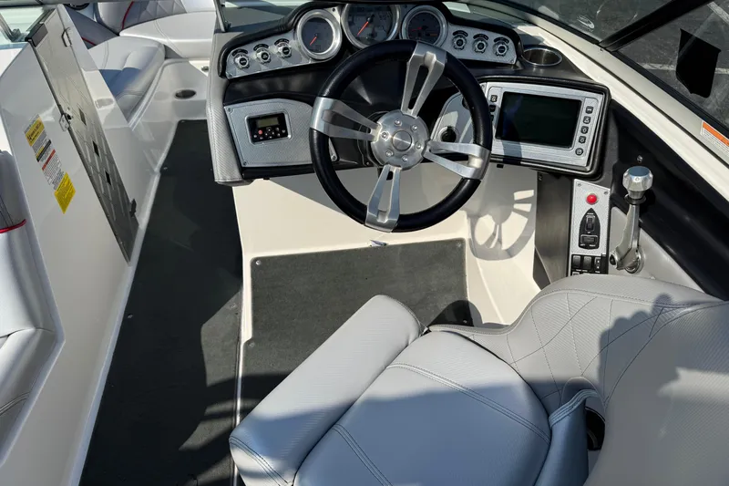 Slide: The Image of 2013 MasterCraft X10 boat cockpit with steering wheel and control panel. - 5