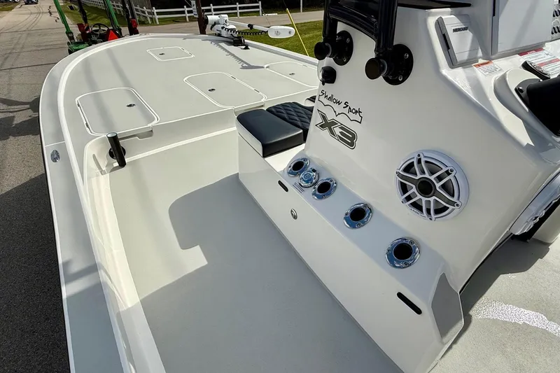 Slide: The Image of 2025 Shallow Sport boat deck with seating, storage, and speaker system. - 12