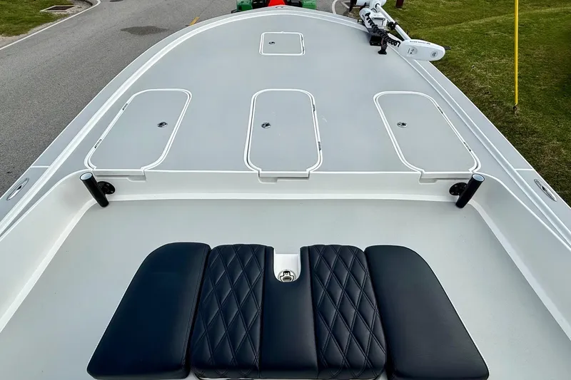Slide: The Image of 2025 Shallow Sport boat deck with cushioned seating and storage compartments. - 13
