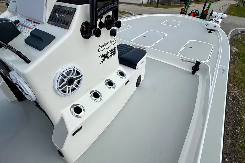 Slide: The Image of 2025 Shallow Sport boat interior with console, seating, and storage compartments. - 14