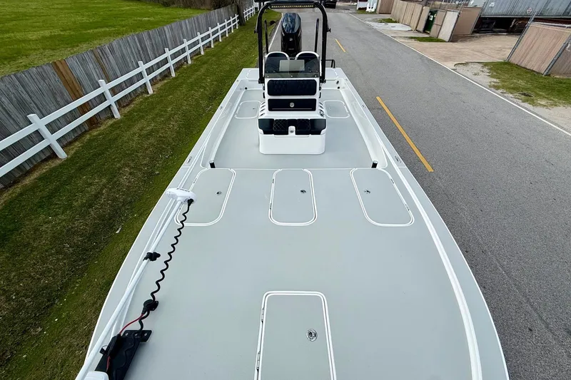 Slide: The Image of 2025 Shallow Sport boat on trailer, featuring spacious deck and modern design. - 15