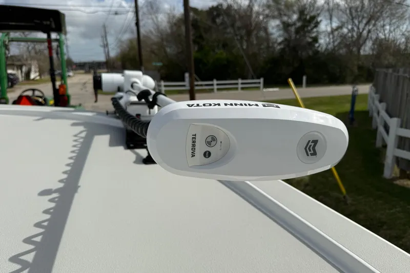 Slide: The Image of Minn Kota Terrova trolling motor on 2025 Shallow Sport boat, outdoor setting. - 17