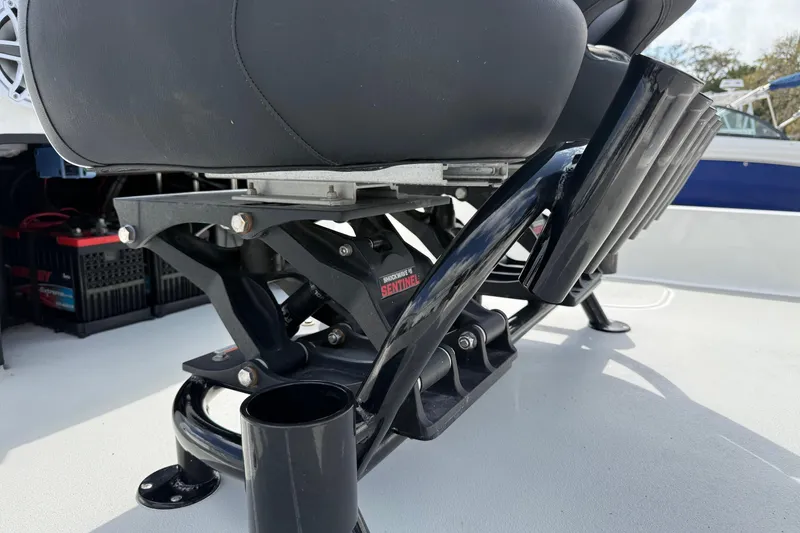 Slide: The Image of 2025 Shallow Sport boat seat with shock absorber and rod holders on deck. - 21