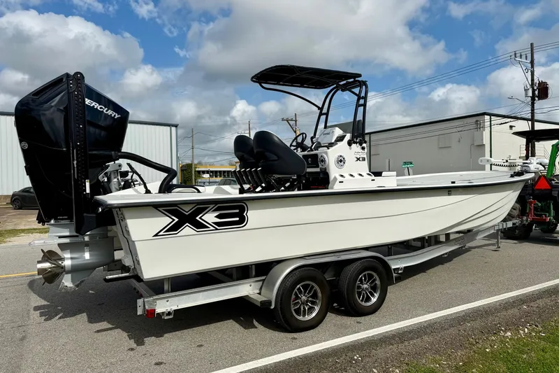 Slide: The Image of 2025 Shallow Sport X3 boat on trailer, featuring Mercury outboard motor, under cloudy sky. - 4