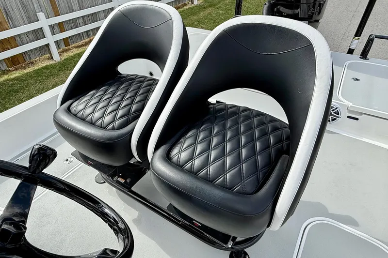 Slide: The Image of Luxurious black leather seats on a 2025 Shallow Sport boat, featuring diamond stitching. - 9