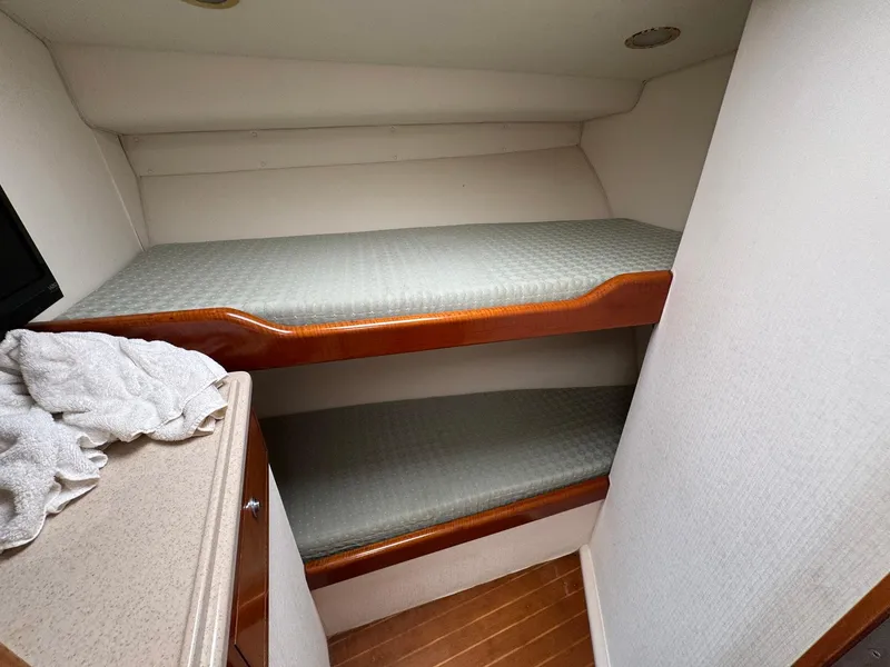 Slide: The Image of Bunk beds in 1999 Cabo 45 Express boat cabin with wooden accents. - 7