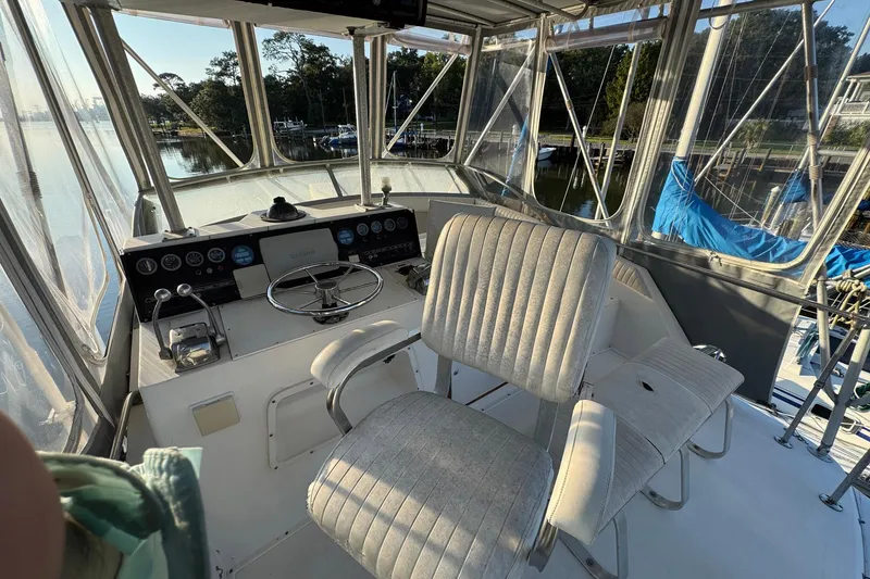 Slide: The Image of 1979 Bertram 38 Convertible boat cockpit with steering wheel and control panel. - 10