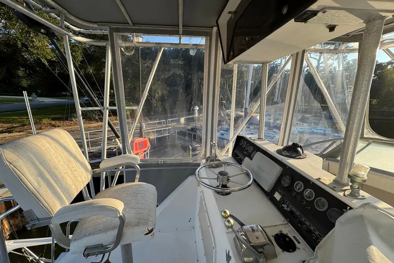 Slide: The Image of 1979 Bertram 38 Convertible boat cockpit with steering wheel and control panel. - 12