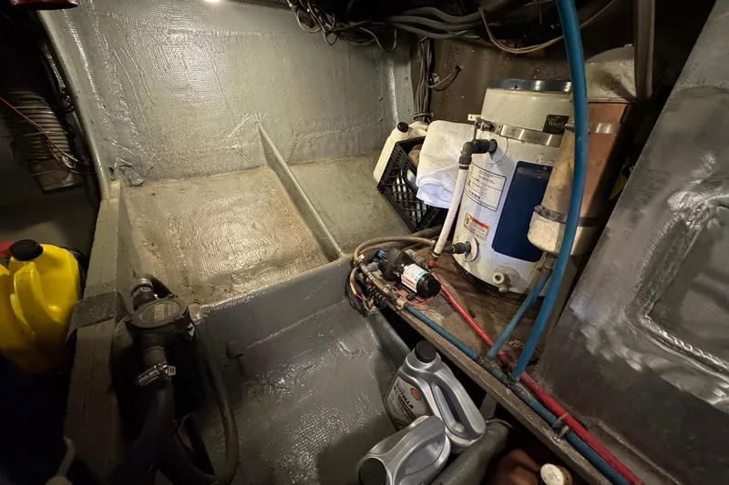 Slide: The Image of Engine room of a 1979 Bertram 38 Convertible boat, showing equipment and maintenance supplies. - 27