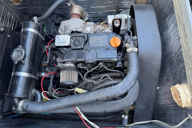 Slide: The Image of Engine compartment of a 1979 Bertram 38 Convertible boat, featuring Isuzu components. - 35