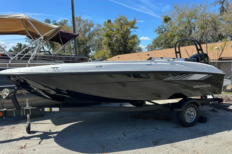 The Image of 2026 Bayliner Element E18 boat on trailer, parked outdoors under clear sky. - 0
