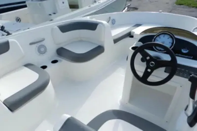 Slide: The Image of 2026 Bayliner Element E18 boat interior with steering wheel and seating. - 10