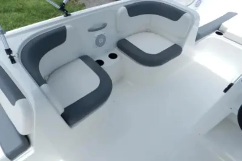 Slide: The Image of 2026 Bayliner Element E18 boat interior with gray and white seating arrangement. - 11