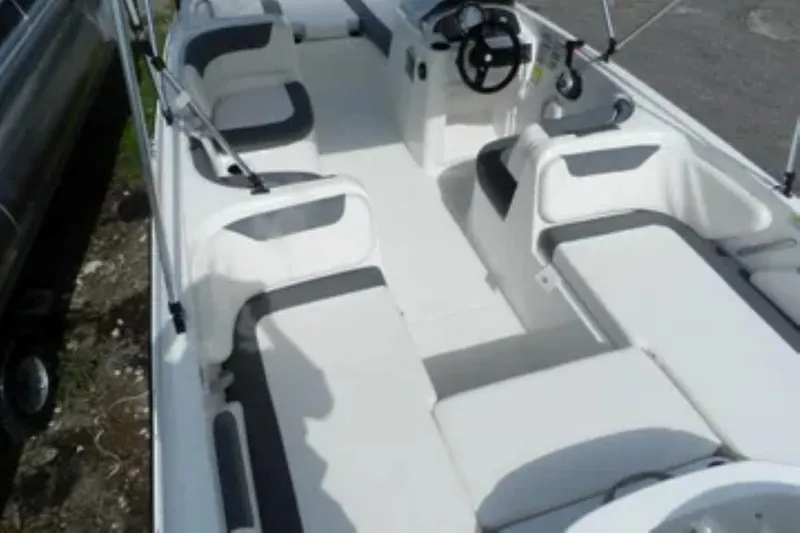 Slide: The Image of 2026 Bayliner Element E18 boat interior with seating and steering wheel. - 13